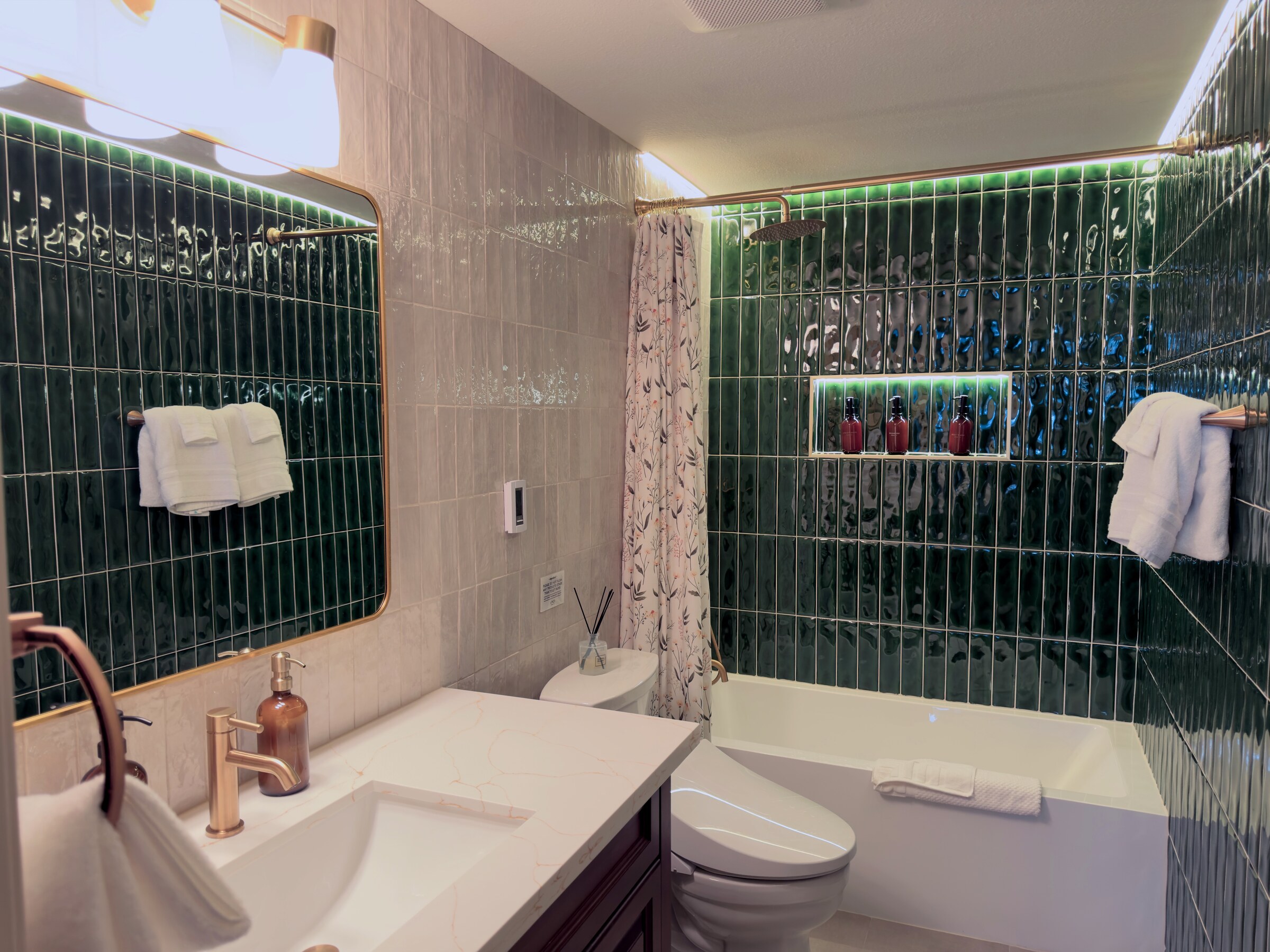 Primary bath — marble vanity, walk-in shower, brass fixtures